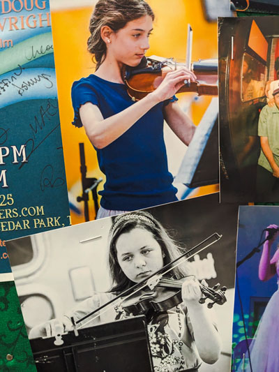 Young girl students play violin at music school recital